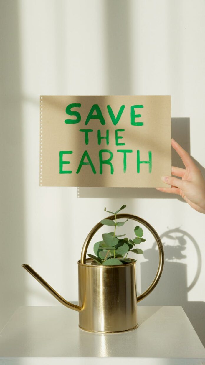 a person holding a save the earth sign